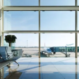 View of planes from the window of the gate area at an airport