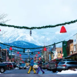 Photo of Whitefish, Montana in wintertime with skiers crossing a street.