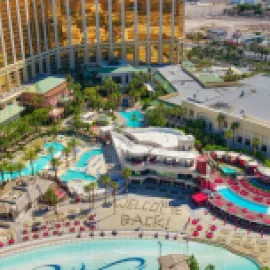 Aerial photo of Mandalay Bay Resort and Casino with the words "welcome back" in the sand on its beach.