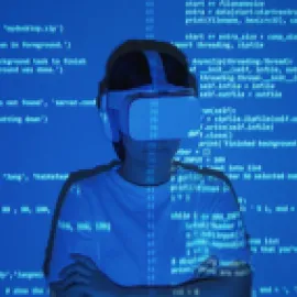 Image of woman with VR goggles on with computer code projected on her.