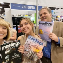 Photo of Meetings Today editors at booth at 2022 IMEX America.