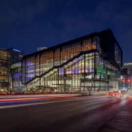 Photo of exterior of Seattle Convention Center Summit building at night.