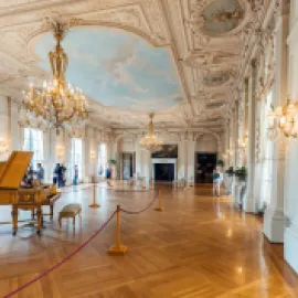 Photo of Newport, Rhode Island's Rosecliff Mansion with grand piano in the foreground.