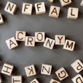 A photo of blocks in an array that spells out "acronyms"