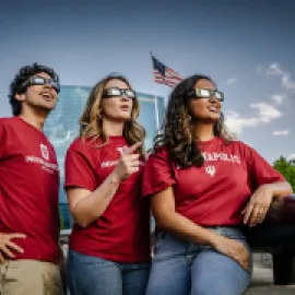 People looking up at the solar eclipse with eclipse glasses on. Photo Credit Cliff Ritchey and Visit Indy