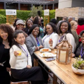 Clara Carter (middle) with attendees at the 2024 WITH Conference