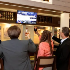 Colleagues watching a game together at the Sonoma Lobby Bar at DoubleTree by Hilton At SeaWorld in Orlando