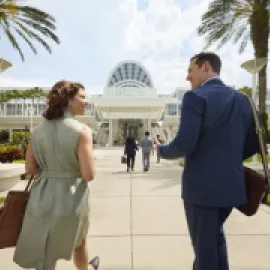 Two attendees walking into the Orange County Convention Center in Orlando