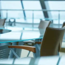 Modern conference room with windows and a glass table