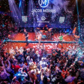 Photo of packed room with celebrants and confetti at Friends in Low Places honky-tonk.