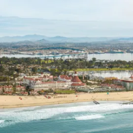 Aerial photo of Coronado island, with a beach and the Del Coronado in the foreground.