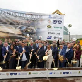 officials hold shovels at groundbreaking ceremony