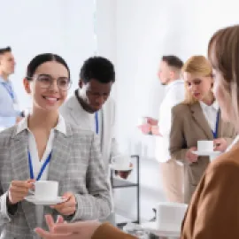 young businesspeople talking while drinking coffee