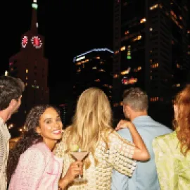 Five people enjoy Dallas night life. 