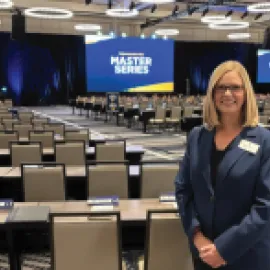 planner standing in back of ballroom