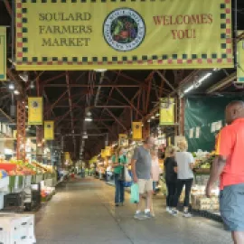 Photo of a man walking through the Soulard District in St. Louis.