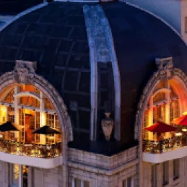 Rooftop balcony of The Bellevue Hotel at night.