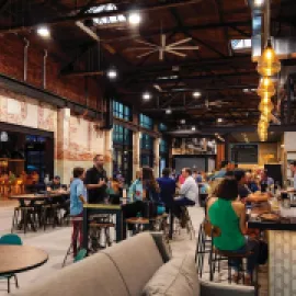 Armature Works food hall, with people sitting at a counter.
