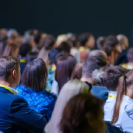 Image of a crowd of people at a meeting.