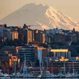 Skyline of Seattle from the waterfront, with Mt. Rainier in the background.