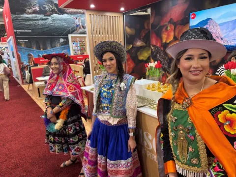 Peru Travel employees stand by their booth at IMEX America. 