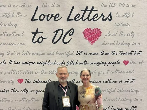 Senior Contributor Jeff Heilman and Melissa A. Riley, SVP of convention sales and services for Destination DC at Love Letter wall at IMEX.