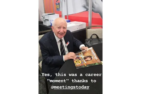 Ray Bloom reads Meetings Today magazine's September issue. 