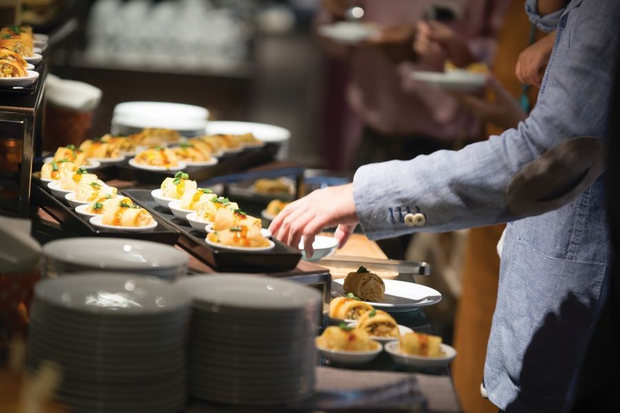 Person accessing a buffet table.