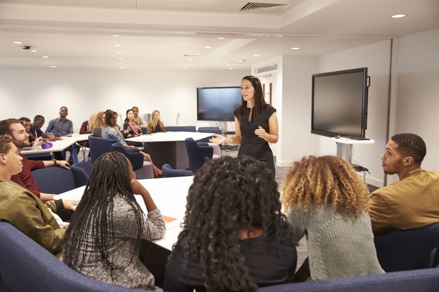 Photo of teacher instructing a college class.