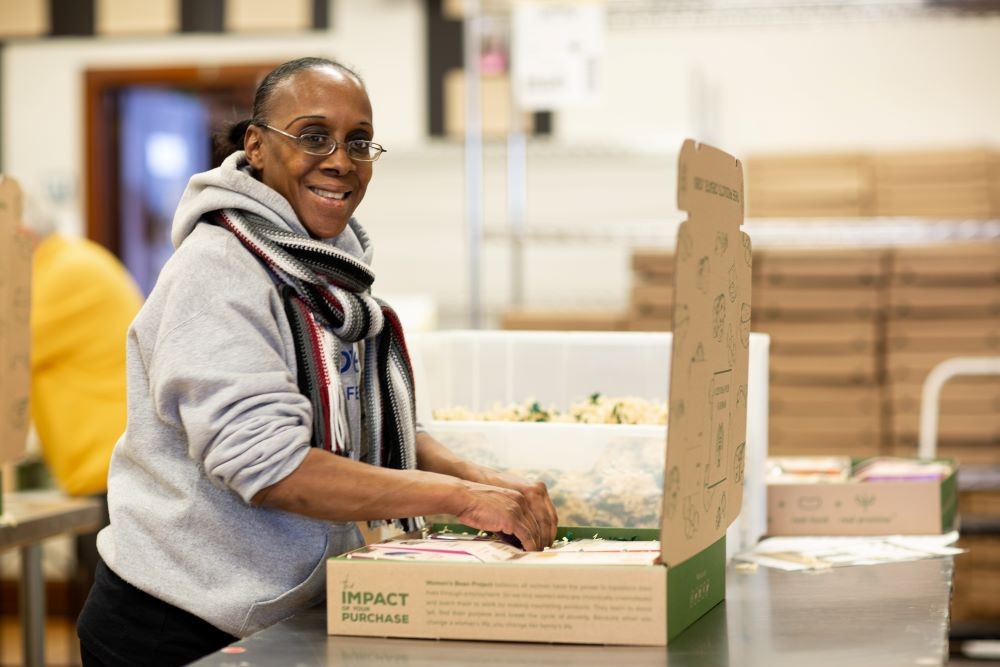 A Program Participant from Women’s Bean Project Makes Snacks and Baking Mixes for Gift Assortments. CREDIT: Lauri Pastrone.