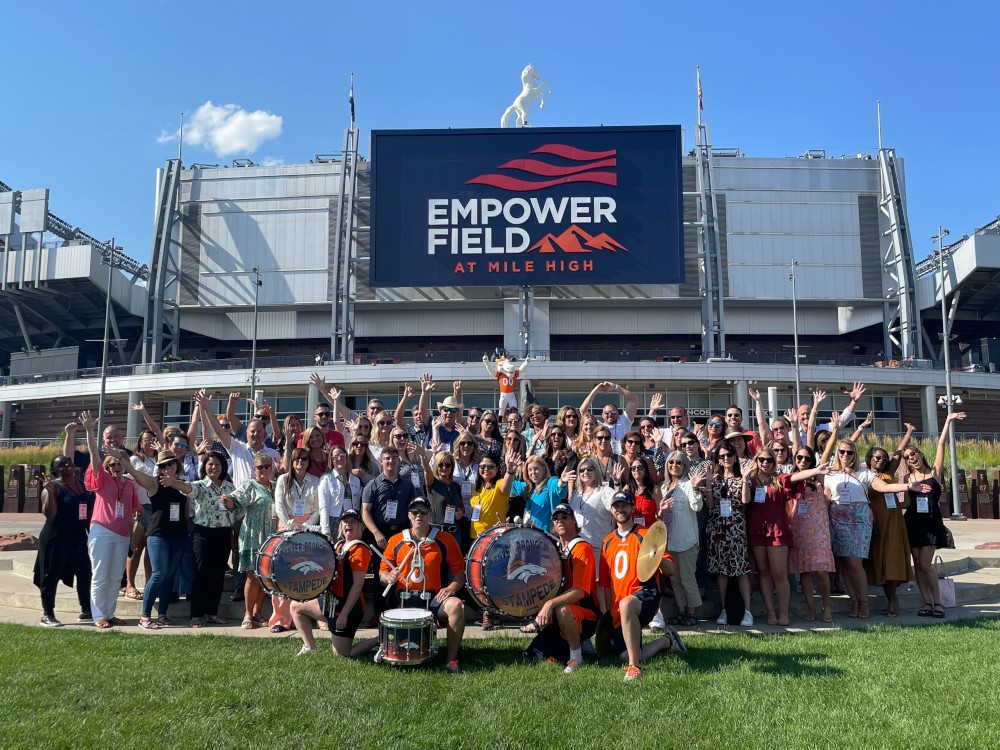 Group shot at Meetings Today LIVE! outside of Empower Field in Denver