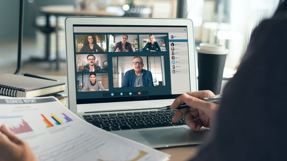 Hybrid events image of people in a virtual meeting on a laptop.