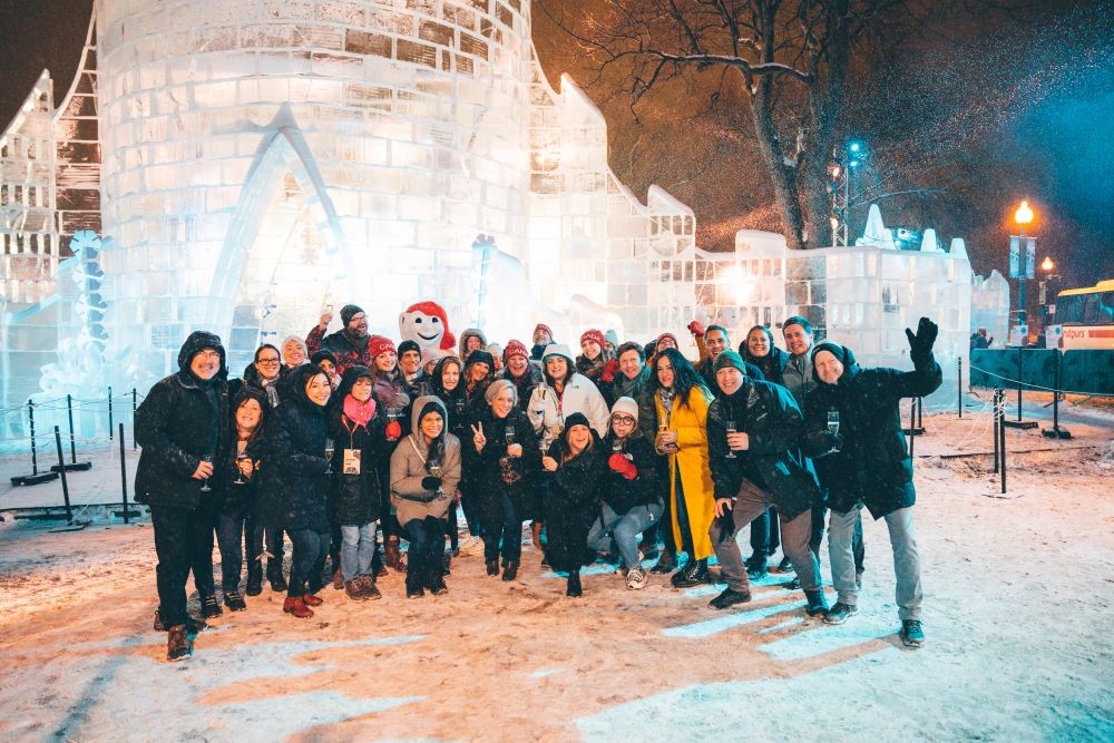 The group poses for a photo with Bonhomme outside his ice castle