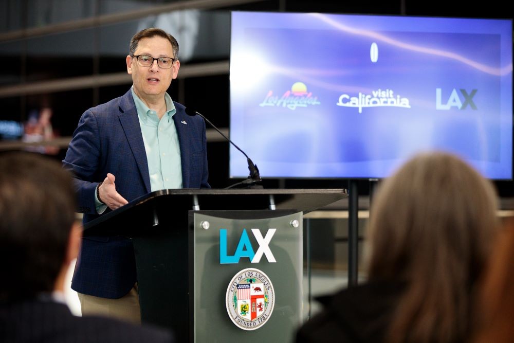 Photo of Adam Burke speaking at Visit California event.