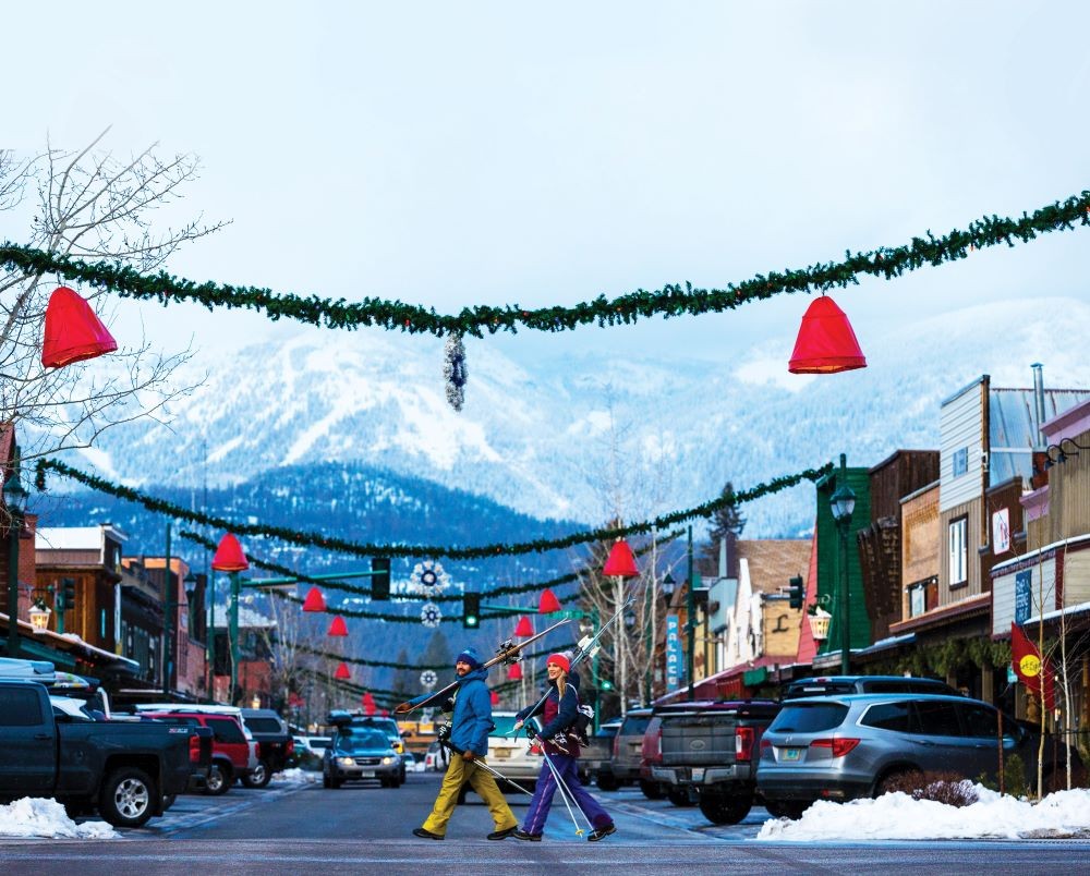 Photo of Whitefish, Montana in wintertime with skiers crossing a street.