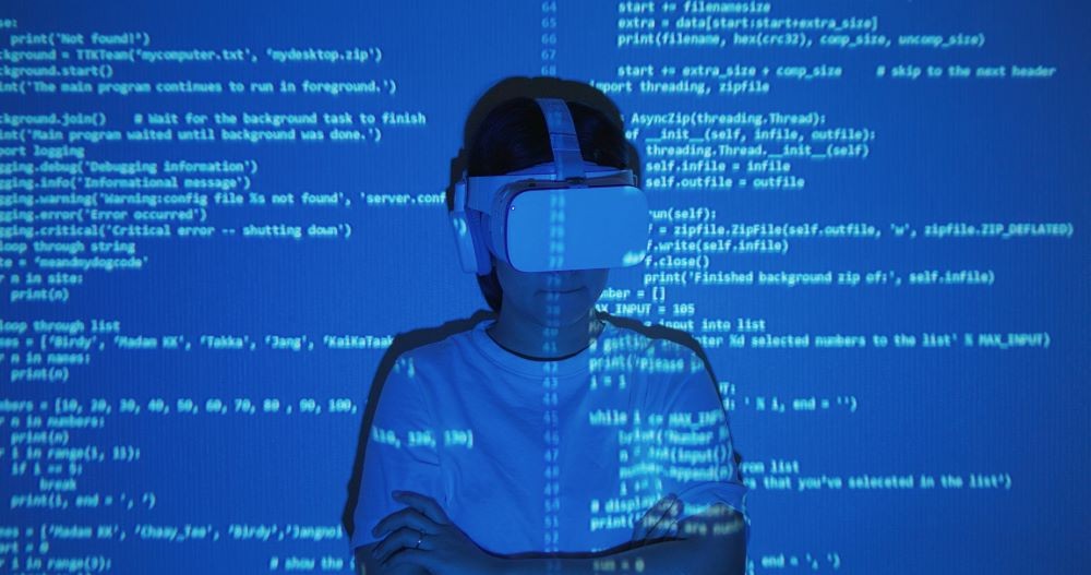 Image of woman with VR goggles on with computer code projected on her.