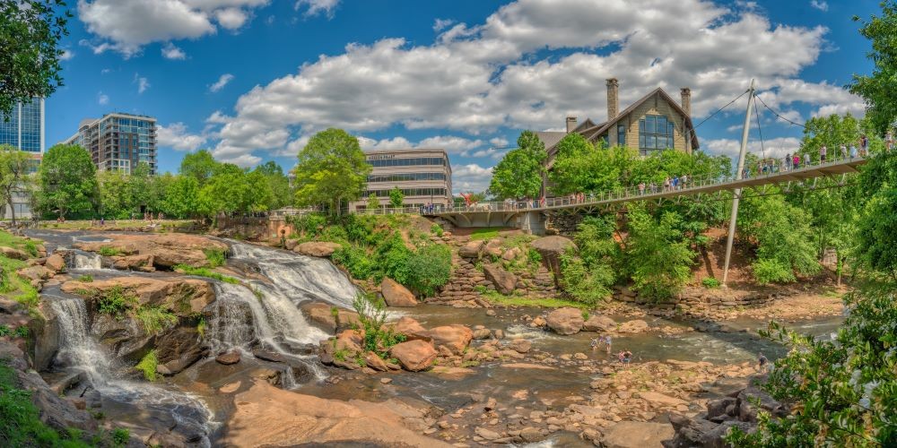 Photo of Reedy Falls and Liberty Bridge with Grand Bohemian Lodge Greenville in the background.