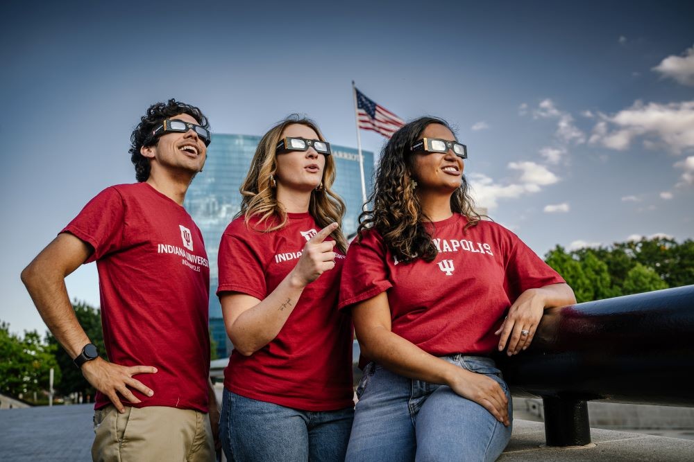 People looking up at the solar eclipse with eclipse glasses on. Photo Credit Cliff Ritchey and Visit Indy