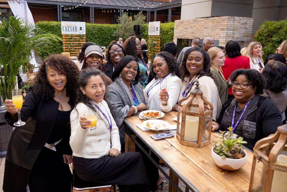 Clara Carter (middle) with attendees at the 2024 WITH Conference