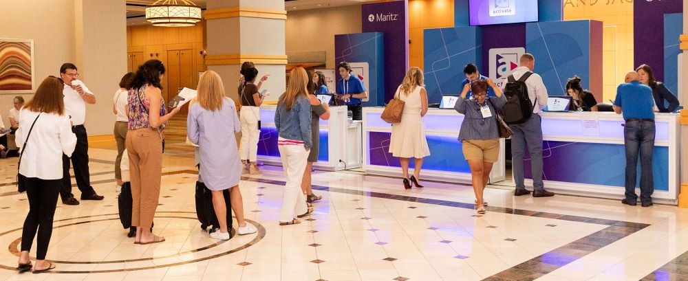 Photo of attendees at a Maritz registration desk.