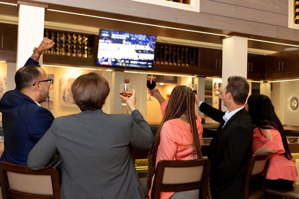 Colleagues watching a game together at the Sonoma Lobby Bar at DoubleTree by Hilton At SeaWorld in Orlando