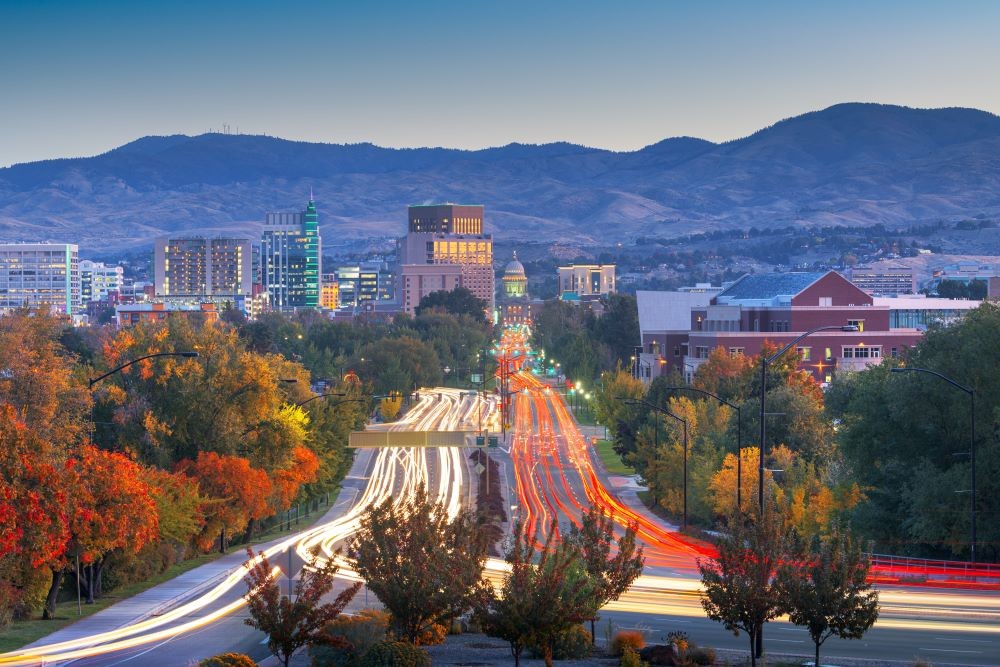 Photo of downtown Boise from a freeway with car lights.