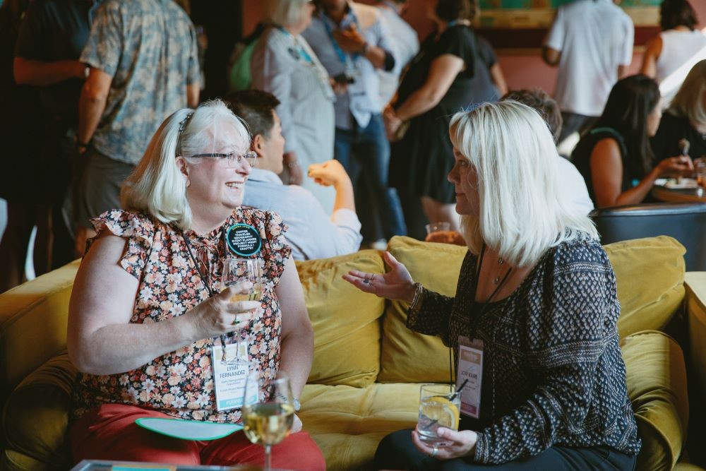 Attendees chat at Hap Hap Lounge dinner event, sponsored by TMN Events.