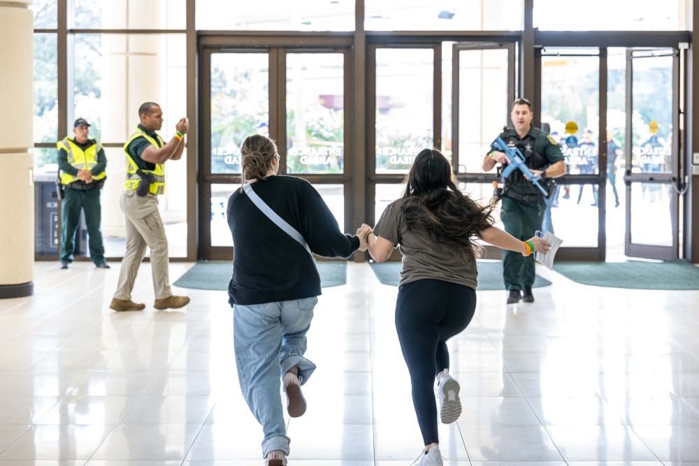 Photo of two people running during a security exercise at Orange County Convention Center.