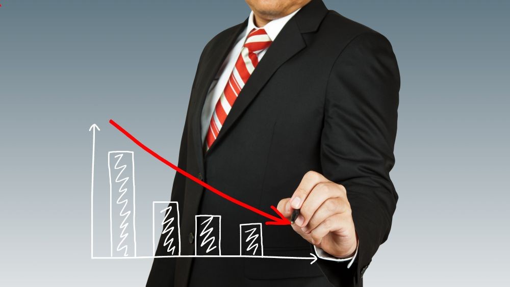 Graphic of a business man tracing a downward arrow.