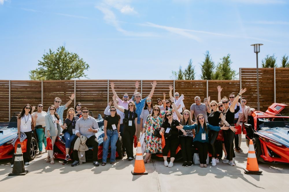 Meetings Today LIVE! National attendees pose by Slingshots