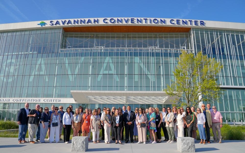 Photo of Savannah convention center and DMO community gathered in front of the expanded Savannah Convention Center.