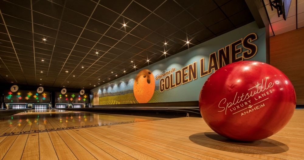 Photo of a red bowling ball in a bowling alley.