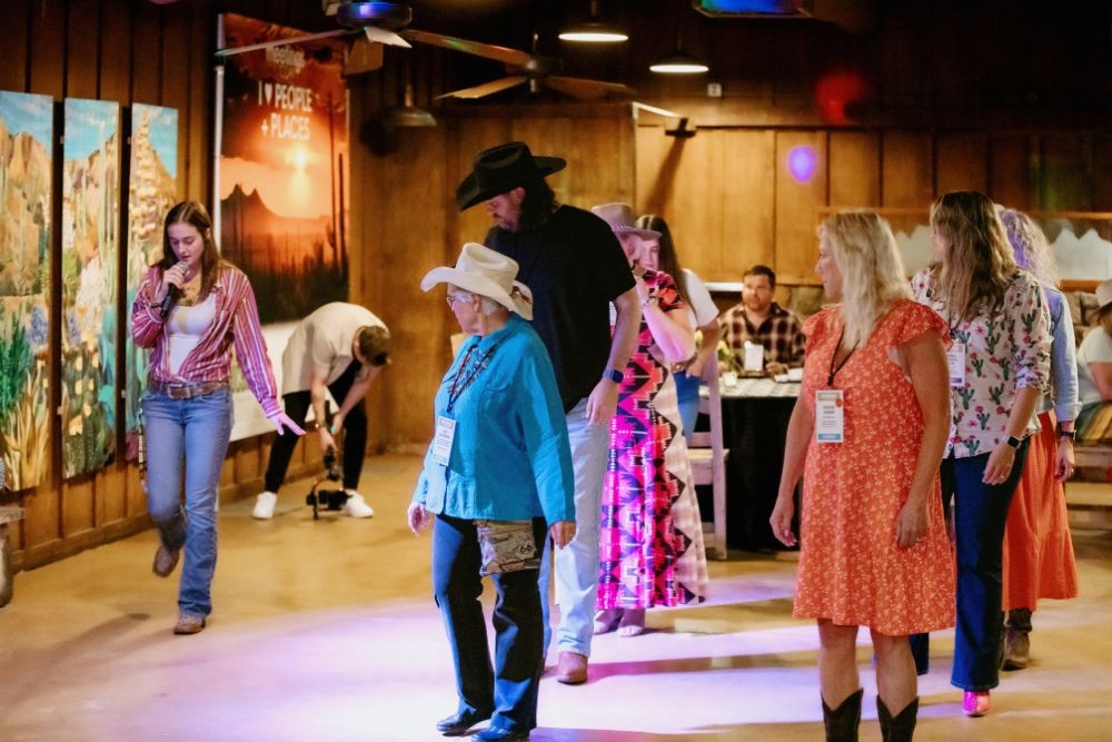 Line dancing lessons at Meetings Today LIVE! West opening reception. Credit: Wandering Maverick Photo+Film