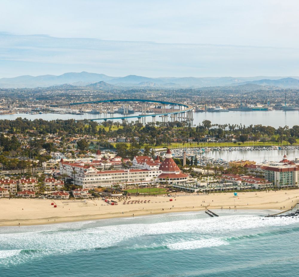 Aerial photo of Coronado island, with a beach and the Del Coronado in the foreground.